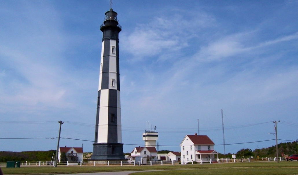 The Cape Henry Lighthouse, a tall white structure, overlooks Virginia Beach in January, showcasing its historic significance.