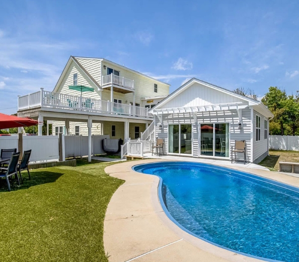 A remodeled house in Virginia Beach featuring a pool and deck, showcasing enhanced curb appeal.