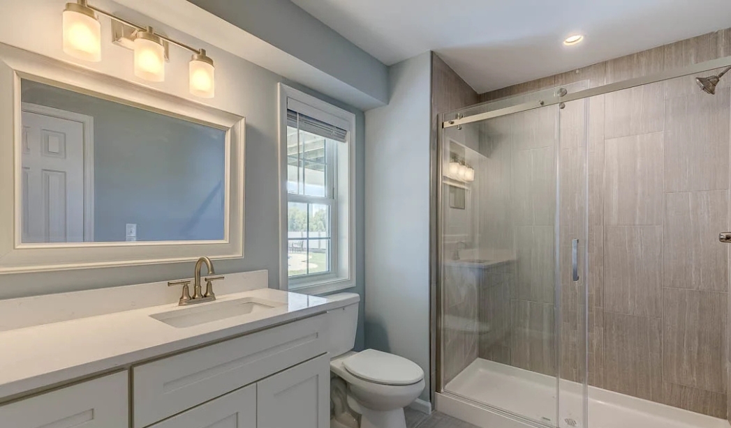 A stylish bathroom with a shower stall and toilet, representing bathroom upgrade services available in Virginia Beach.