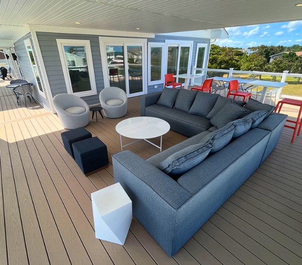 A well-furnished deck showcasing cozy couches and tables, designed for leisure and gatherings in Virginia Beach.
