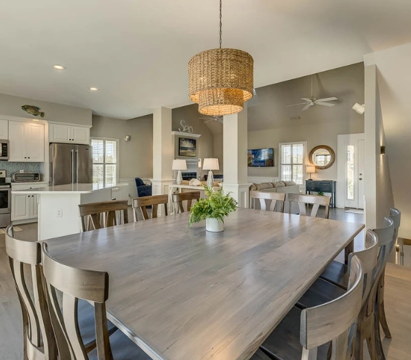 An expansive kitchen and dining room with elegant furniture, highlighting luxury remodeling services in Virginia Beach.