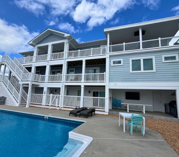 Exterior view of a house with a pool and decking, highlighting remodeling services available in Virginia Beach.