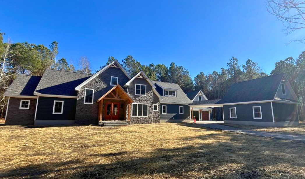 A prominent home with black siding and windows, built by Cape Henry Virginia Beach Homebuilders located in Back Bay.