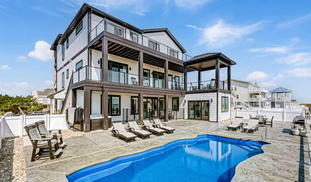 A large home in Kempsville, Virginia Beach, featuring a pool and deck, showcased by A Shell-A-Bration homebuilders.