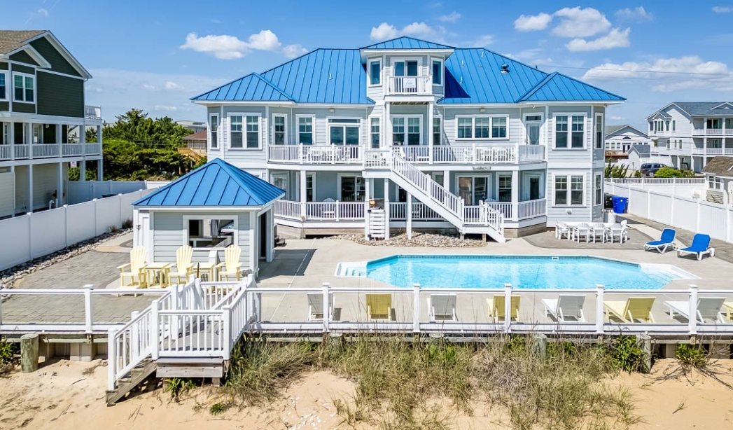 Beach house with a pool and deck, showcasing Red Mill Virginia Beach Homebuilders