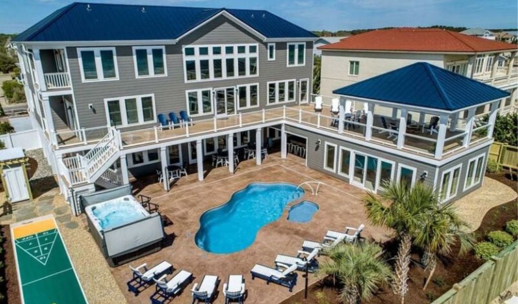 Spacious house with a pool and deck, highlighting the design excellence of Strawbridge Virginia Beach Homebuilders.