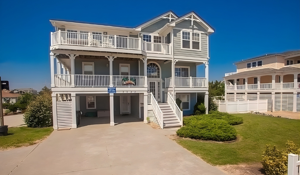 A beach house in Virginia Beach featuring a spacious deck and stairs, designed by Strawbridge Homebuilders