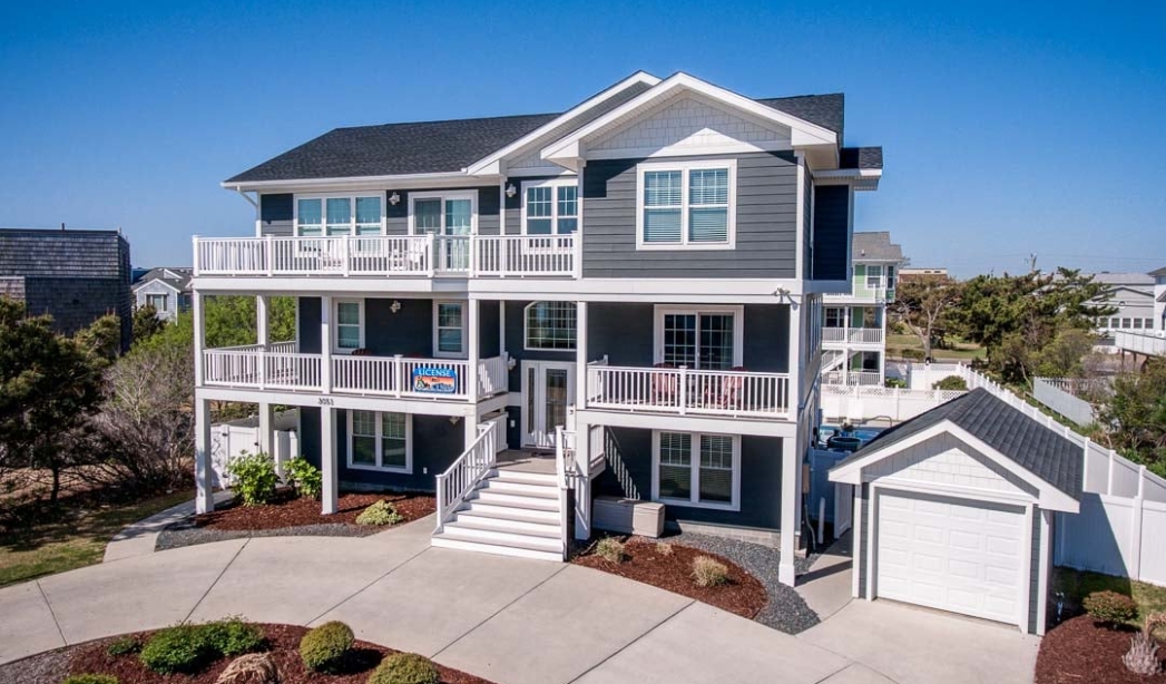 Virginia Beach home showcasing a large deck and front porch, designed for comfort and leisure in a tranquil setting.