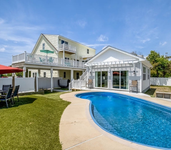 A residential property with a pool and deck, showcasing a garage conversion in Virginia Beach aimed at increasing value.