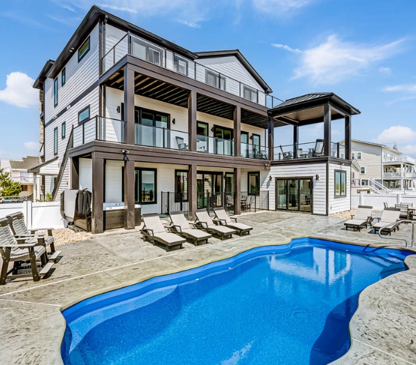 Spacious home with a pool and deck, highlighting a garage conversion project in Virginia Beach for quicker completion.