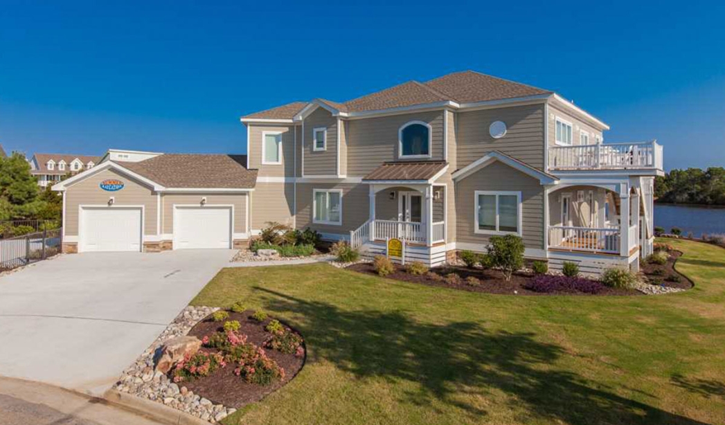 A prominent house with an expansive driveway and garage, highlighting a garage conversion project in Virginia Beach.