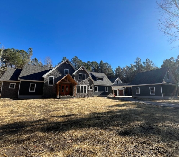 A large home with a spacious driveway and yard, showcasing a garage conversion in Virginia Beach without the need for expansion.