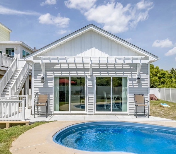 A modern house featuring a pool and deck, showcasing a home remodel project in Virginia Beach.