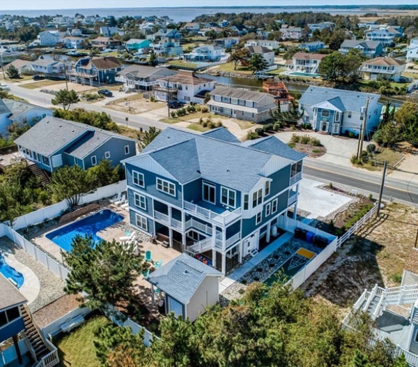 Aerial view of a beach house featuring a pool, showcasing local coastal design expertise in Virginia Beach.