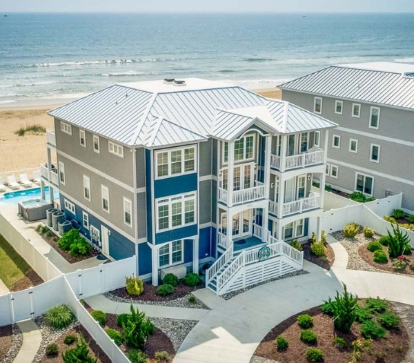 A beachfront residence with a pool and deck, highlighting the expertise of a Virginia Beach home contractor.