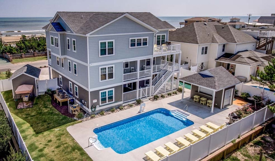 A modern house with a pool and deck, showcasing a stylish outdoor living space in Virginia Beach.A modern house with a pool and deck, showcasing a stylish outdoor living space in Virginia Beach.