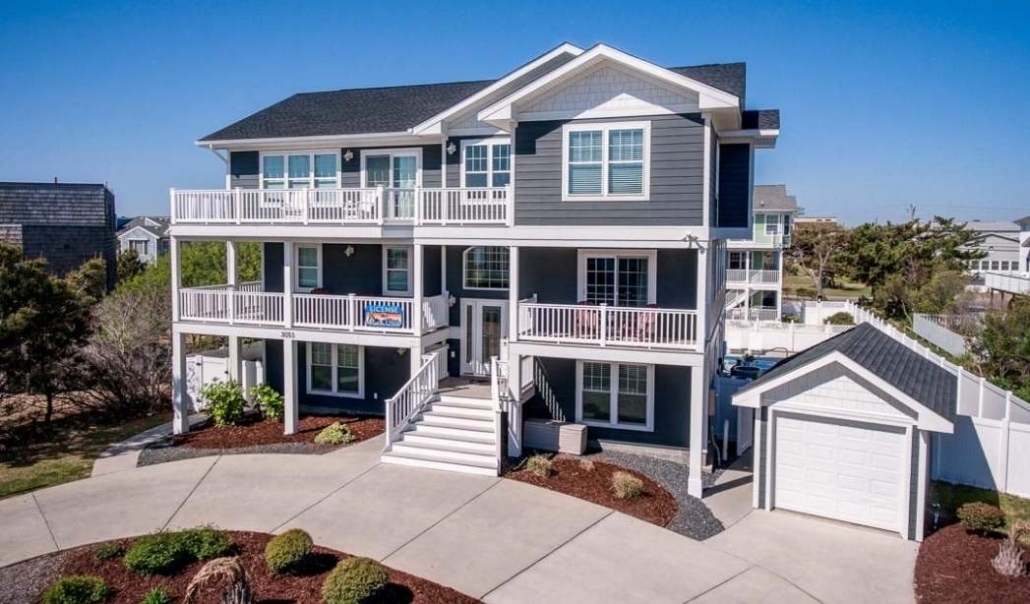 A two-story house with a spacious deck, highlighting common errors in garage-to-home office conversions.