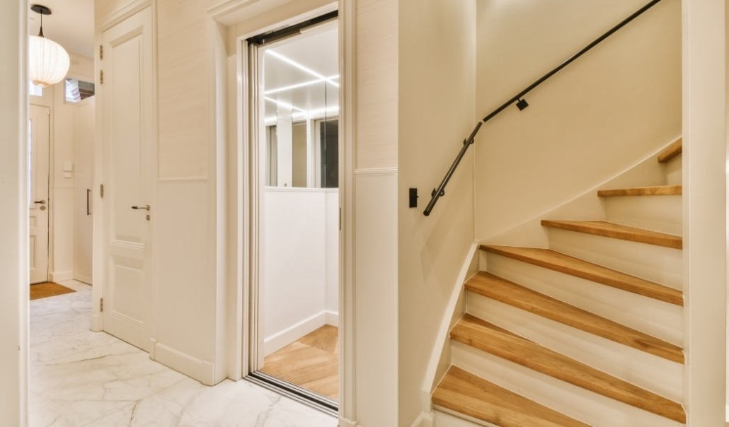 Home elevator addition beside staircase for safe and accessible retirement living
