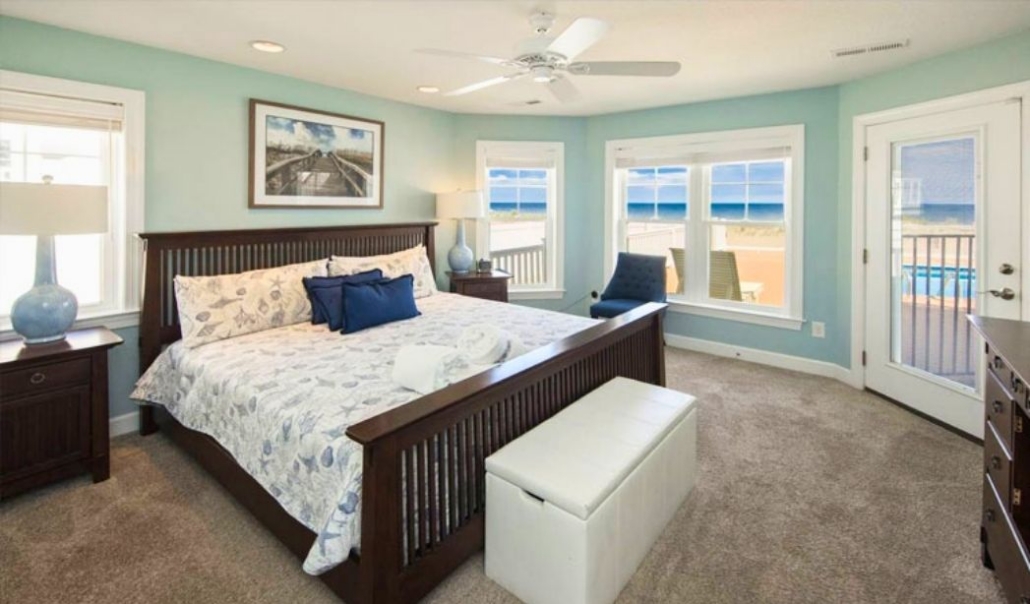 Bright custom bedroom featuring large windows for natural light and energy savings.