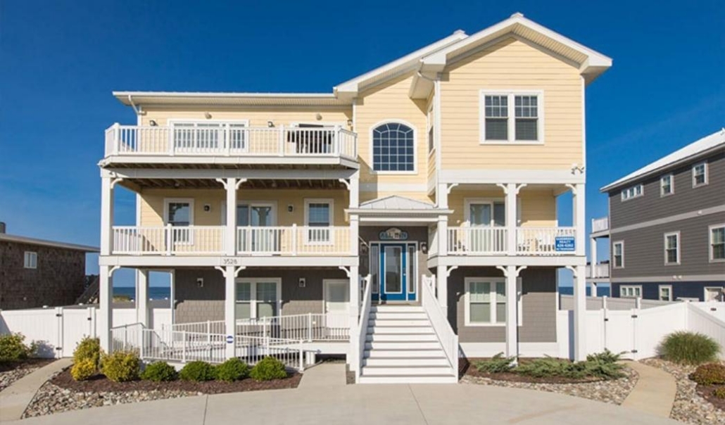 Finished custom beach home highlighting exterior architecture, balconies, and elevated design.