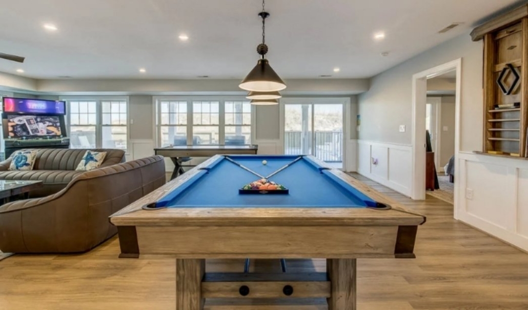 Custom home entertainment space with pool table and open-concept layout