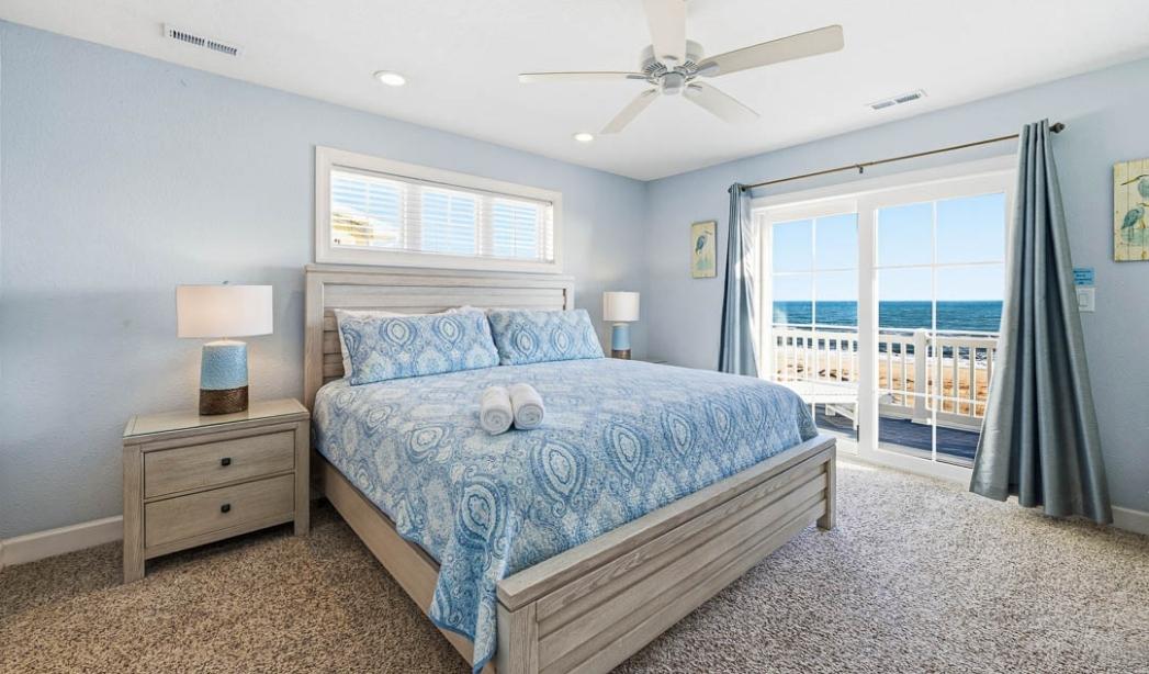 Oceanfront bedroom in a Virginia Beach rental, ideal for military families and defense contractors.