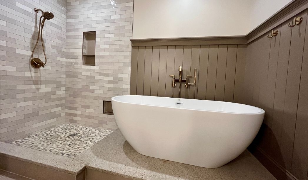 Bathroom addition with freestanding tub and tiled walk-in shower in a Virginia Beach home