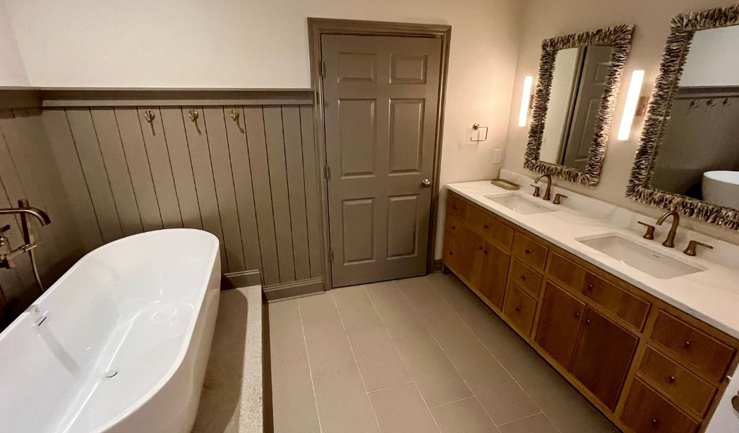 Bathroom addition with freestanding tub and double vanity designed for aging in place