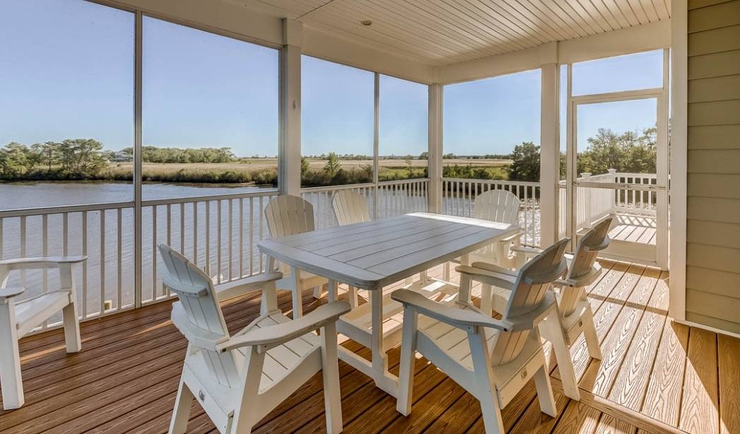Sunroom addition with waterfront views and outdoor dining in a Virginia Beach home