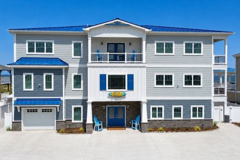 Custom coastal home in Virginia Beach with blue metal roofing and modern exterior finishes.